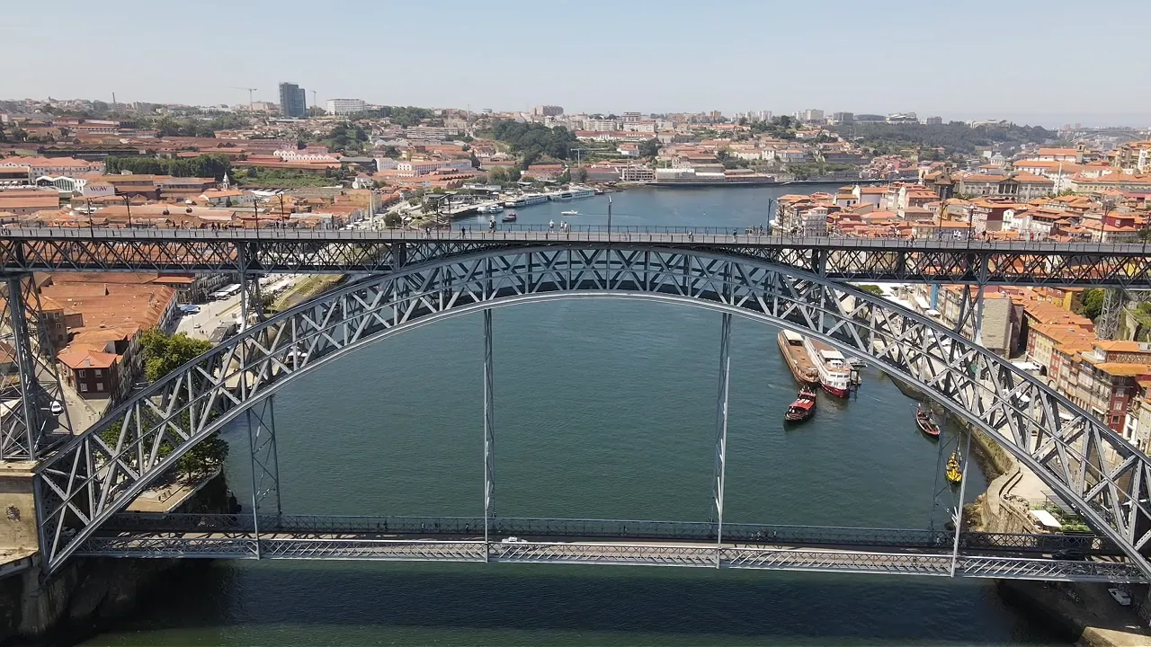 The Douro river and the Dom Luís I bridge seen from a drone, with Porto's Ribeira on one bank and Gaia on the other